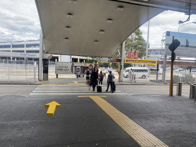 Airport crosswalk with people walking in the distance.
